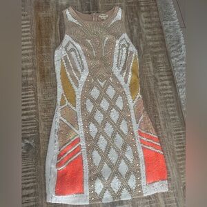 Elegant Beaded Dress in Gold, White, and Orange. Perfect for festivities.